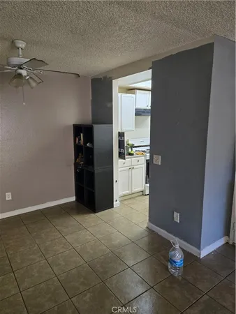 a kitchen with granite countertop a refrigerator and a stove top oven