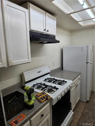 a kitchen with a stove and a refrigerator
