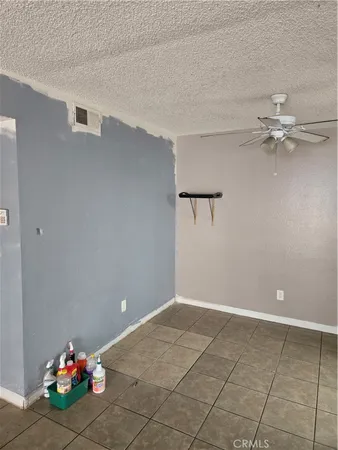 a view of a room with a ceiling fan