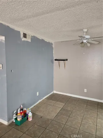 a view of a room with a ceiling fan