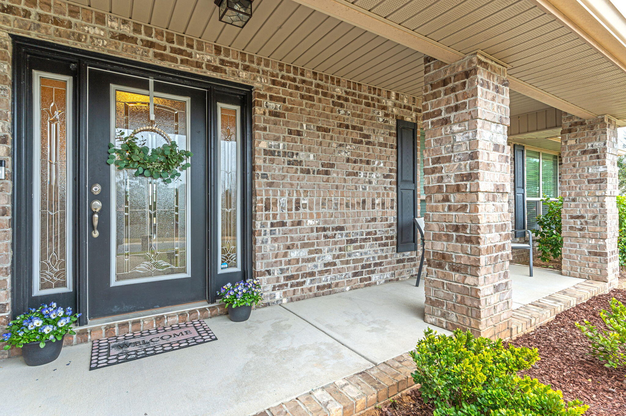 a front view of a house with a garden