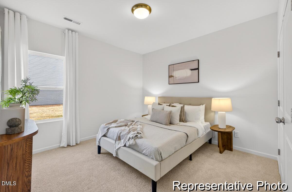 421 Plentiful Way, Unit 111 Benson, NC 27504 - Photo 20 of 27 a bedroom with a bed and a window