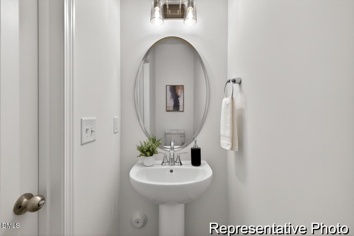 421 Plentiful Way, Unit 111 Benson, NC 27504 - Photo 10 of 27 a bathroom with a sink and a mirror