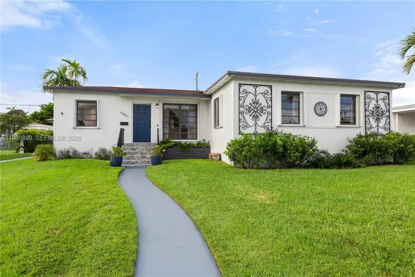 a front view of house with yard and green space