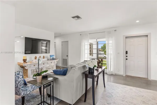 a view of a livingroom with furniture and a flat screen tv
