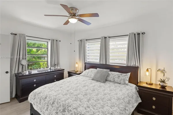 a bedroom with a large bed and a window