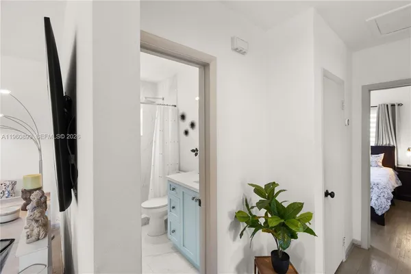 a view of a hallway with a potted plant on a bathroom