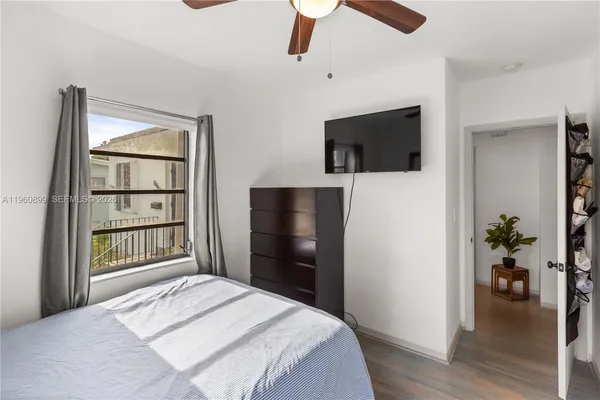 a bedroom with a bed and a television