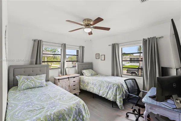 a bedroom with two beds and a window