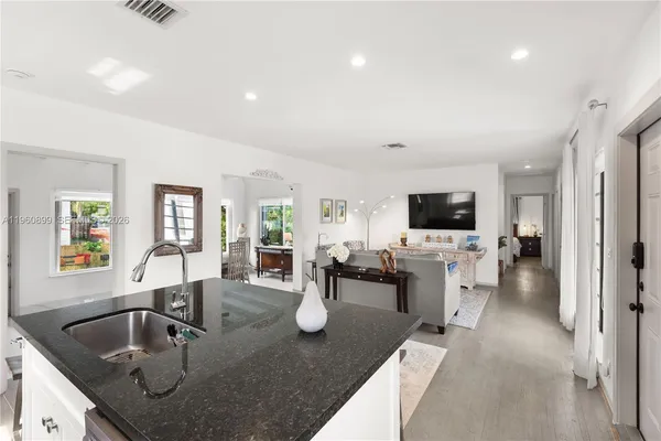 a kitchen with sink and refrigerator