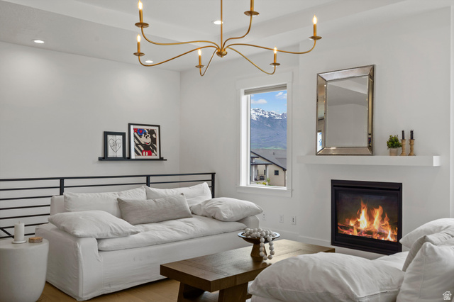 3349 Oxford Loop Morgan, UT 84050 - Photo 10 of 47 Living area with suspended lighting, wood finished floors, a glass covered fireplace, and a mountain view
