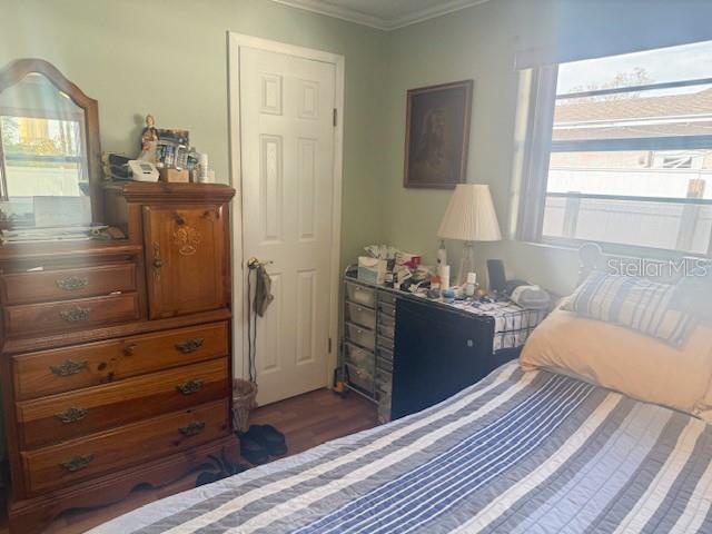 13157 Clay Avenue Largo, FL 33773 - Photo 14 of 20 a room with a bed and a mirror on dresser