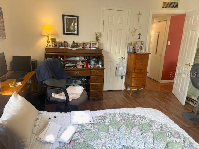 13157 Clay Avenue Largo, FL 33773 - Photo 9 of 20 a bed room with a bed and a chair