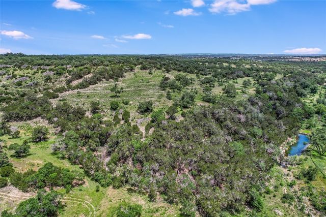 a view of a city with lush green forest