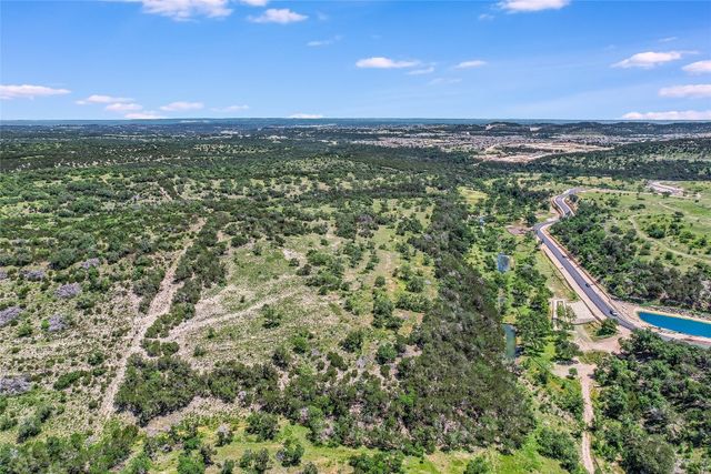 a view of a city with lush green forest