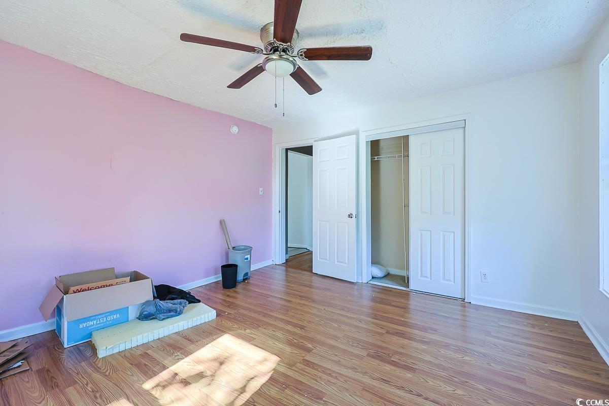 4300 Summit Trail Myrtle Beach, SC 29579 - Photo 12 of 39 Unfurnished bedroom featuring wood finished floors, a closet, a ceiling fan, and a textured ceiling