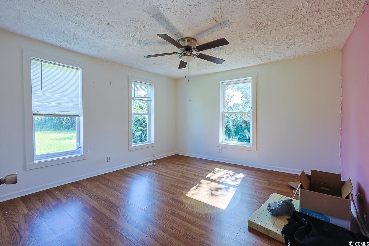 4300 Summit Trail Myrtle Beach, SC 29579 - Photo 13 of 39 Unfurnished room featuring wood finished floors, a textured ceiling, and a ceiling fan