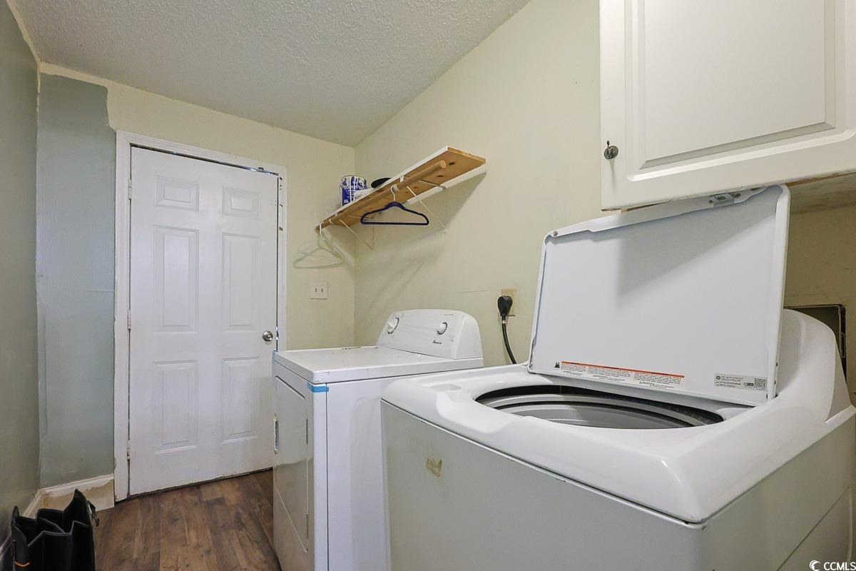 4300 Summit Trail Myrtle Beach, SC 29579 - Photo 20 of 39 Washroom featuring a textured ceiling, dark wood finished floors, washer and clothes dryer, and cabinet space