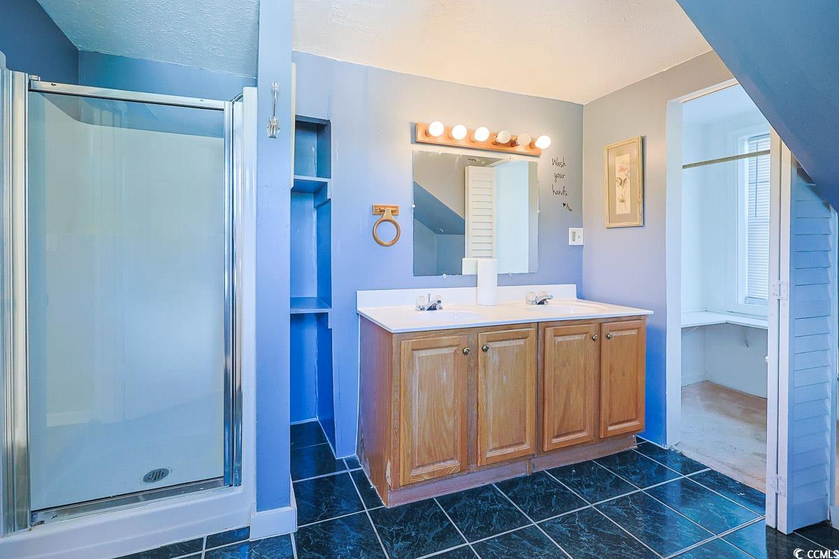 4300 Summit Trail Myrtle Beach, SC 29579 - Photo 28 of 39 Full bathroom featuring a stall shower, double vanity, and dark tile patterned floors
