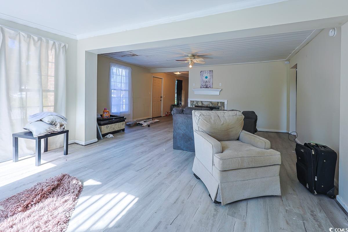 4300 Summit Trail Myrtle Beach, SC 29579 - Photo 3 of 39 Living room featuring light wood-type flooring, ceiling fan, and ornamental molding