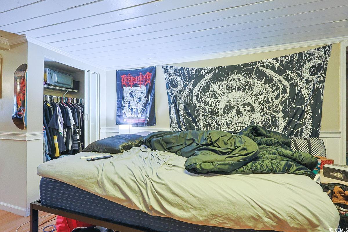 4300 Summit Trail Myrtle Beach, SC 29579 - Photo 32 of 39 Bedroom with a closet, ornamental molding, and wood finished floors