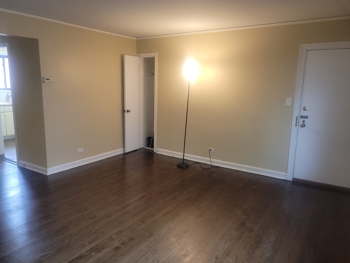 1540 Ashland Avenue, Unit 1 River Forest, IL 60305 - Photo 4 of 12 an empty room with wooden floor and windows with curtains