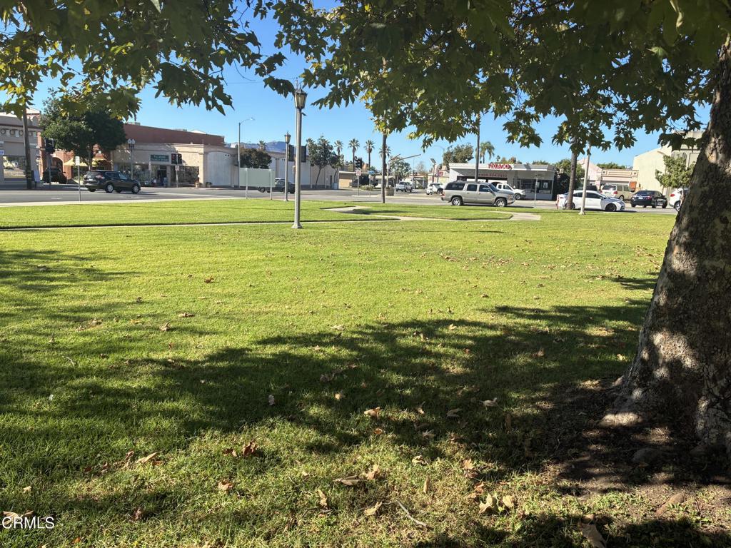 404 Central Avenue Fillmore, CA 93015 - Photo 6 of 16 a view of a large pool with lawn chairs under an umbrella
