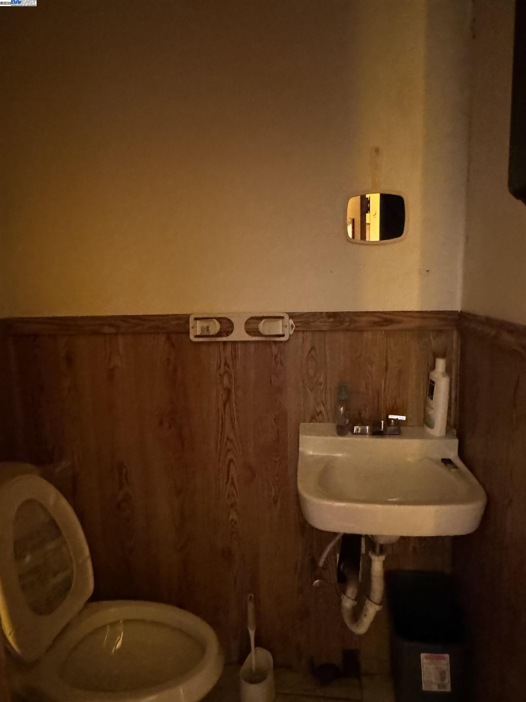 1124 63rd Street Oakland, CA 94608 - Photo 8 of 15 a bathroom with a sink a toilet