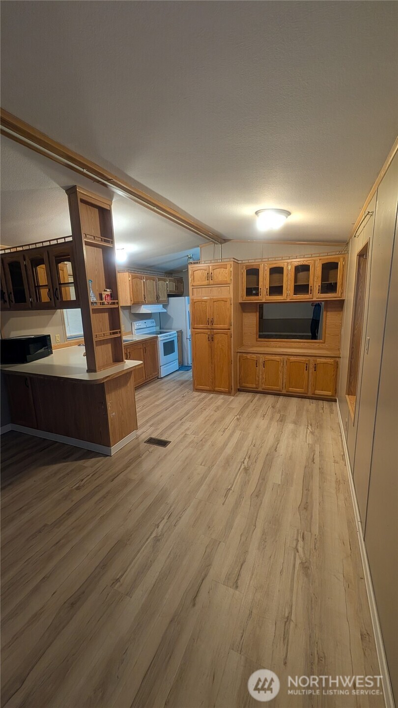 17340 Sargent Road Southwest, Unit 66 Rochester, WA 98579 - Photo 6 of 11 a view of a living room hardwood and kitchen