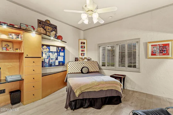 a bedroom with a large bed and a chandelier