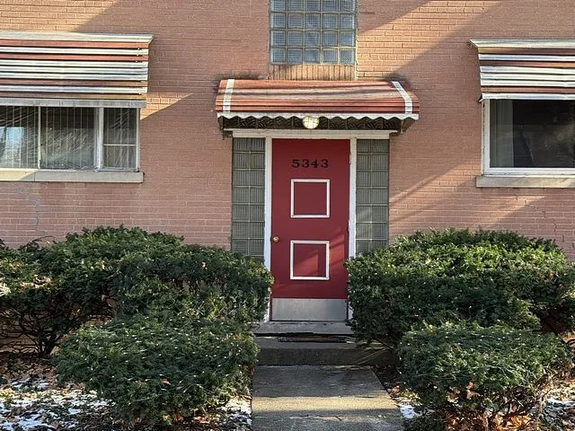 a view of staircase with railing and white walls