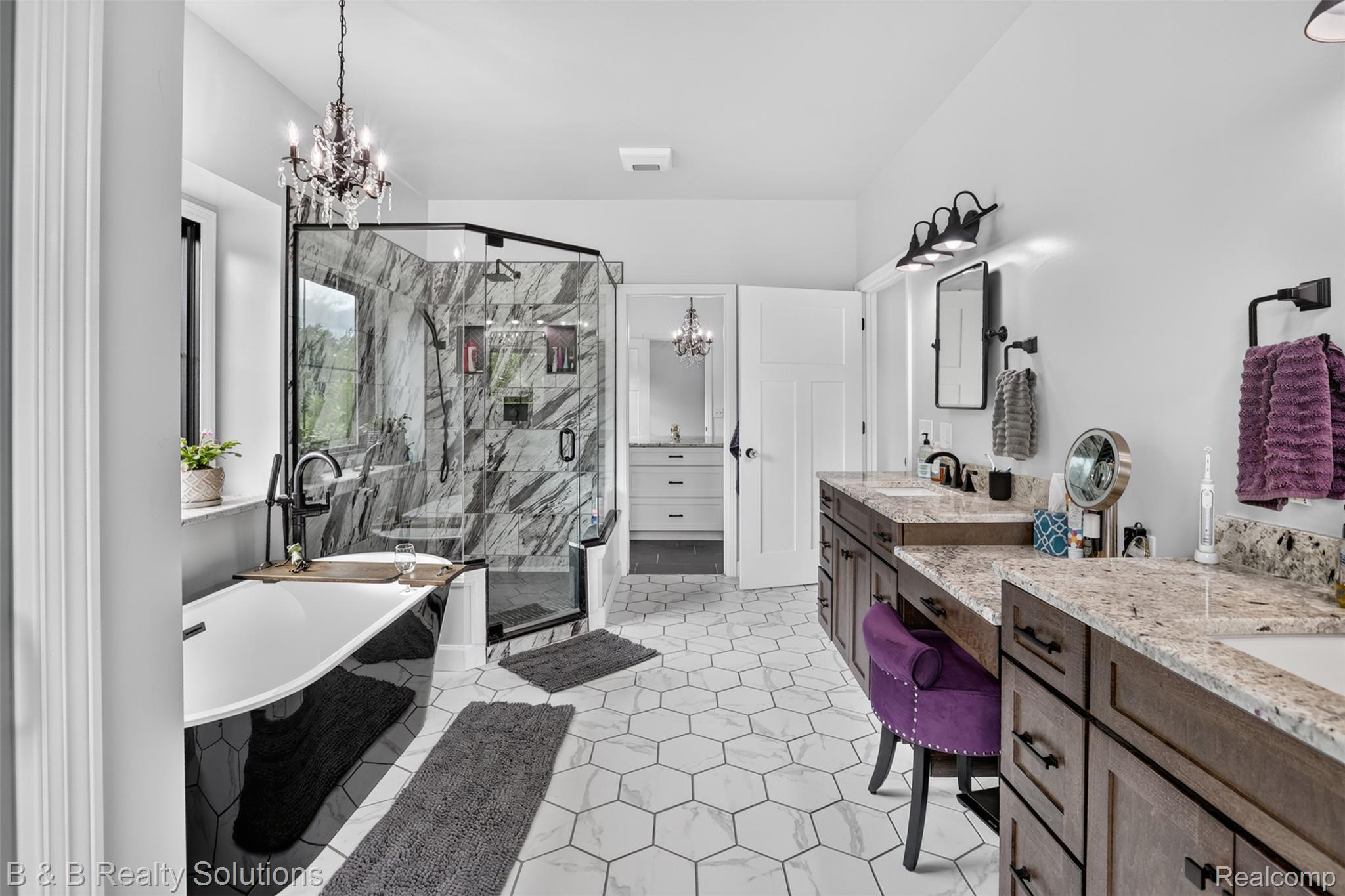 6204 Fish Lake Road North Branch, MI 48461 - Photo 24 of 79 Spacious bathroom featuring a freestanding black and white soaking tub, a glass-enclosed shower with marble-finish walls, dual vanities with stone countertops, and hex tile flooring