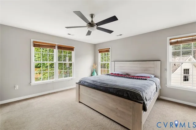 a bedroom with a large bed and a large window