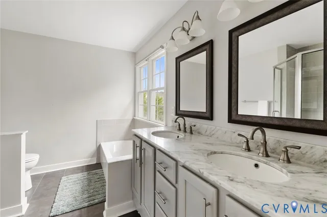 a bathroom with a sink double vanity granite and a mirror