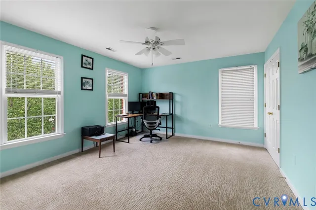 a livingroom with workspace and a window