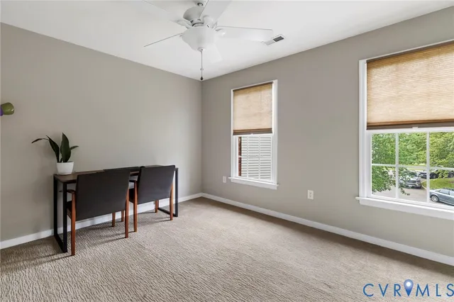 a view of a livingroom with a window and a chandelier