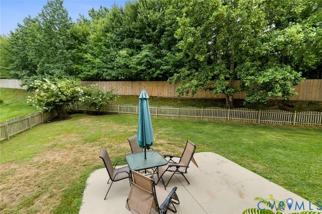 a view of a chair and table on the garden