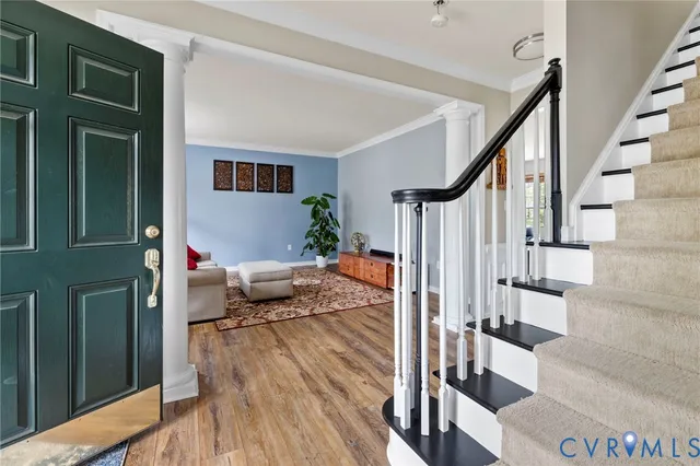 a living room with furniture and a wooden floor