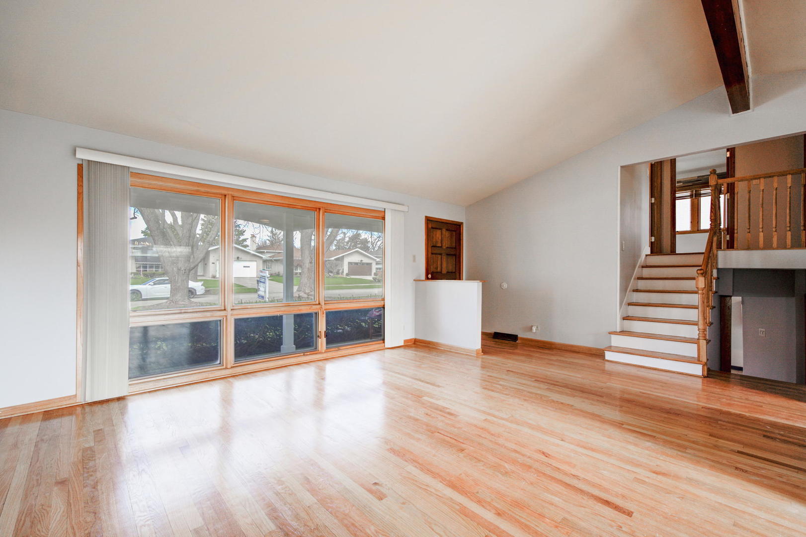 2317 High Ridge Parkway Hillside, IL 60162 - Photo 5 of 24 a view of an empty room with wooden floor and a window