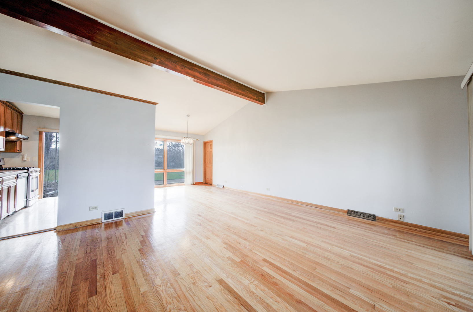 2317 High Ridge Parkway Hillside, IL 60162 - Photo 6 of 24 a view of an empty room with wooden floor and a window