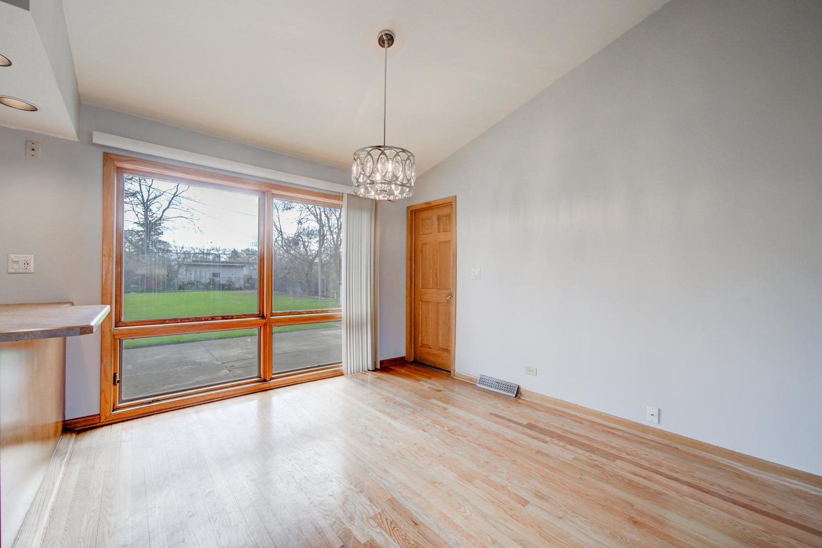 2317 High Ridge Parkway Hillside, IL 60162 - Photo 9 of 24 a view of an empty room with wooden floor and a window