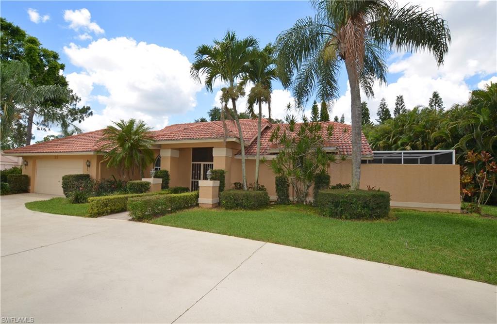 a front view of house with yard and green space