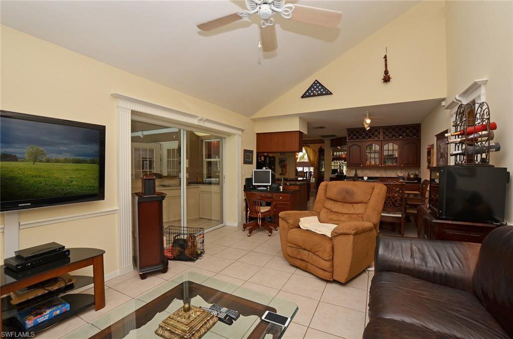 264 Henley Drive Naples, FL 34104 - Photo 11 of 25 a living room with furniture and a flat screen tv