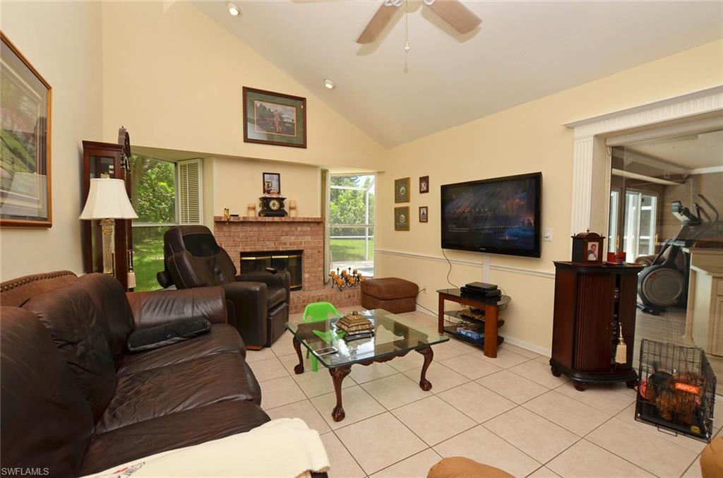 264 Henley Drive Naples, FL 34104 - Photo 12 of 25 a living room with furniture and a flat screen tv