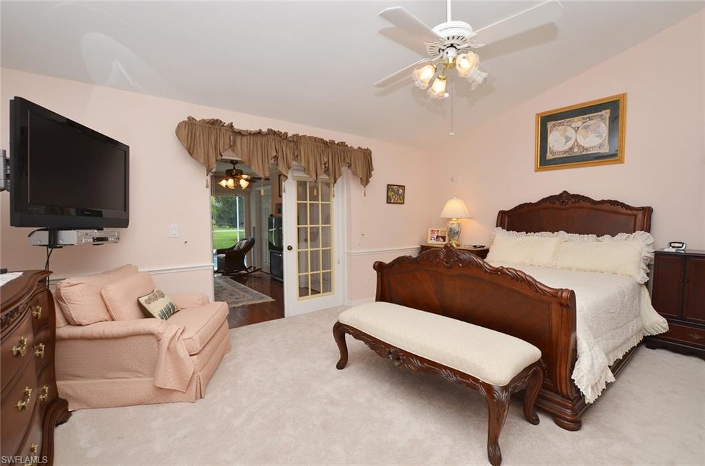 264 Henley Drive Naples, FL 34104 - Photo 13 of 25 a living room with furniture and a flat screen tv