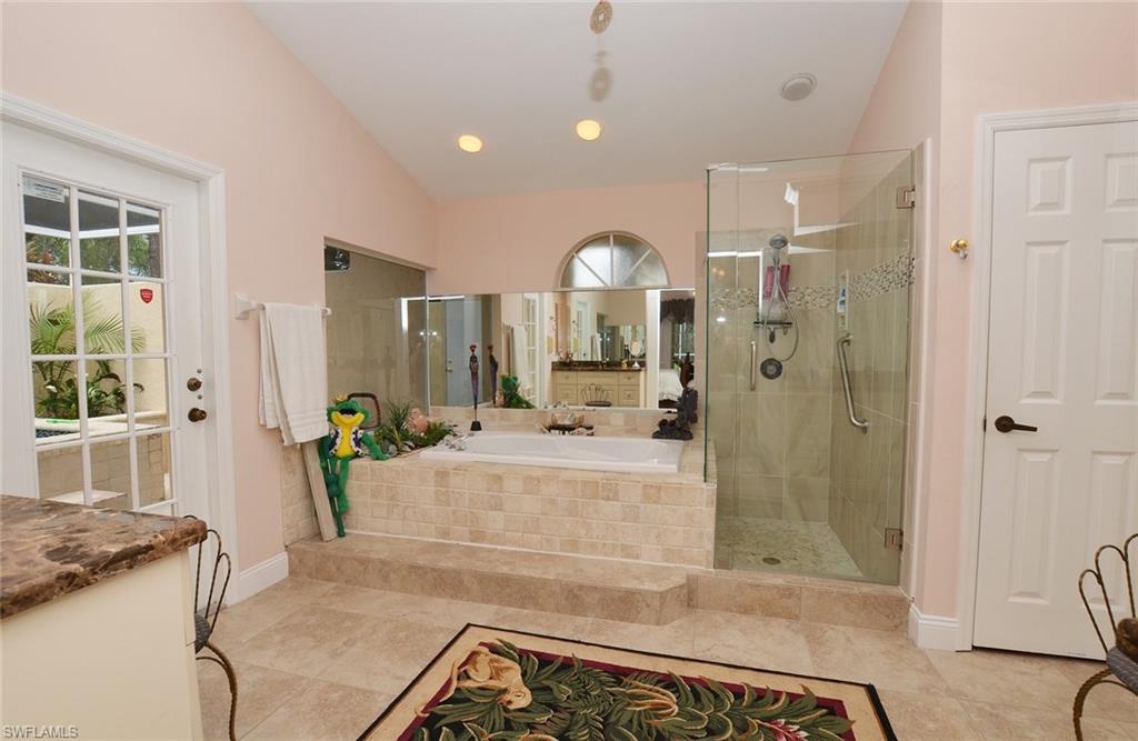 264 Henley Drive Naples, FL 34104 - Photo 15 of 25 a large bathroom with a tub shower and sink