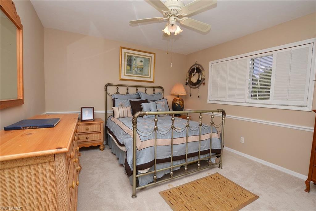 264 Henley Drive Naples, FL 34104 - Photo 18 of 25 a bedroom with a bed and a window