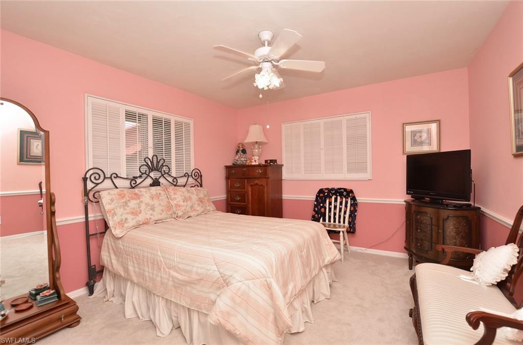 264 Henley Drive Naples, FL 34104 - Photo 20 of 25 a bedroom with a bed and a flat screen tv
