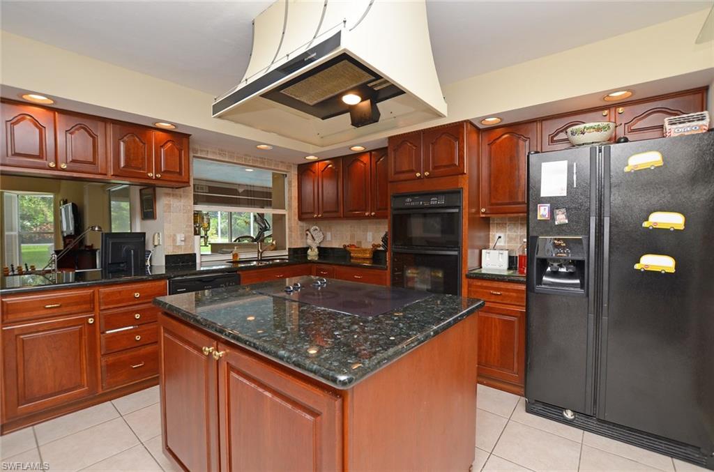 264 Henley Drive Naples, FL 34104 - Photo 2 of 25 a kitchen with stainless steel appliances granite countertop a sink and counter space