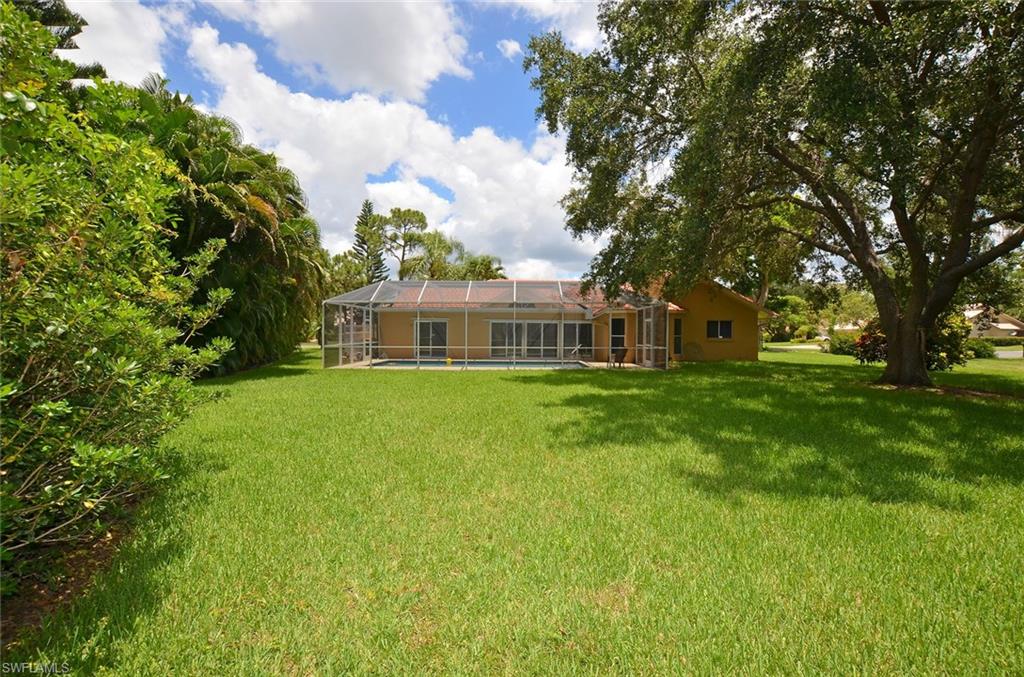 264 Henley Drive Naples, FL 34104 - Photo 24 of 25 a front view of house with yard and green space